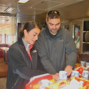 Chanterelle Atkins, left, of Wiscasset and husband Kevin Atkins check out the festive treats aboard the Maine Eastern Railroad's Toys ‘n’ Turkeys Train, during its Wiscasset stop. The special train run on November 16 was a food and toy drive. The local couple donated frozen turkeys. SUSAN JOHNS/Wiscasset Newspaper Wiscasset couple on Maine Eastern Railroad train