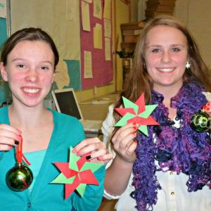 Eighth grade LOAFS Maddie McLellan, left, and Jackie McLoon, hold up snowflakes and balls decorated for the upcoming holiday dance. KATRINA CLARK/Boothbay Register