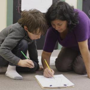 Spanish teacher Lissette Gonzalez-Griffin helps Cleary Risteen with the Spanish alphabet. Courtesy of Tanya Albert, Lisa Truesdell
