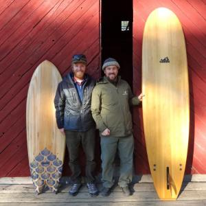 Chewonki Summer Wilderness Programs Director Ryan Linehan, right, and Grain staff member Andrew Gardiner show off two hand-made surfboards in front of the Chewonki barn, as part of the launch of the new Chewonki Board Building Expedition. Courtesy of Chewonki Chewonki, surfing