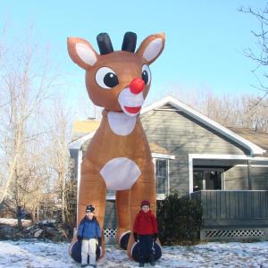 Sam Bowden, 4, left, and brother Luca Bowden, 6, pose with this 15-foot-tall, inflatable Rudolph the Red-Nosed Reindeer, outside the Bowden family home on Bay Street in Boothbay Harbor December 14. SUSAN JOHNS/Wiscasset Newspaper Sam and Luca Bowden Boothbay Harbor Rudolp the Red-Nosed Reindeer