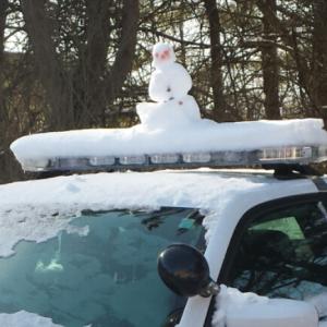 Stay frosty out there: This snowman just wants to go on patrol with the Lincoln County Sheriff’s Office. BEN BULKELEY/Wiscasset Newspaper cop car snowman frosty