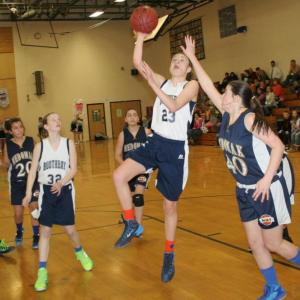 Faith Blethen puts up a running shot for two of her nine points against Medomak in the seventh grade semifinal game at BRES on Thursday, Jan. 23. Boothbay won easily, 47-22. KEVIN BURNHAM/Boothbay Register Blethen