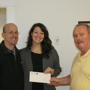 Boothbay Register Editor Kevin Burnham, right, congratulates Jason and Melissa Nein. The couple stopped by the newspaper’s office on Friday, Feb. 14 to pick up their How We Met Valentine’s Contest prize: a $75 gift certificate to Robinson’s Wharf.