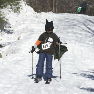 A youth racer competes dressed as their favorite superhero — Batman. Courtesy of Andy McEvoy skiing