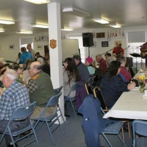 While the musicians play in the corner, attendees enjoy their plates of food at the Marston family fundraiser at the Boothbay Fire Station on Sunday, March 2. KEVIN BURNHAM/Boothbay Register