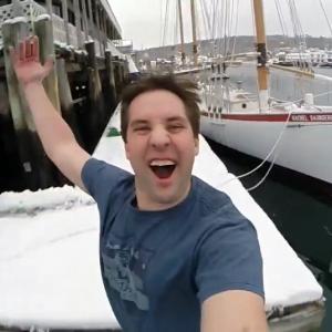 Ryan leighton jumps off a wharf in Boothbay Harbor in February during the making of his video for Mystic Seaport. Courtesy of Ryan Leighton
