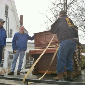 Rotarians, from left, Mohamed Osman, Rick Elder, Daren Graves and Doug Harley, are all smiles despite the heavy lifting taking place as Rotarians cleaned out the old Oak Street Clubhouse and said good-bye for the final time on Saturday March 1. Courtesy of Jennifer Page Osman Rotarians