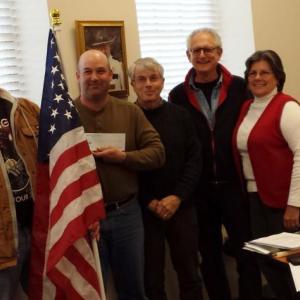 From left, Richard McFarland, Selectmen’s Chairman Joshua Pinkham, and selectmen David Atwater, Ronn Orenstein and Robin Mayer. The Damariscotta Board of Selectmen was recently presented with a $1,000 check for insurance from the American Legion to be able to hang American flags throughout downtown during the summer. BEN BULKELEY/Wiscasset Newspaper