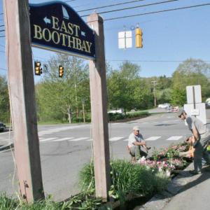 Jeffrey DiMauro, left, owner of East Boothbay Landscaping and his crew members begin planting flowers on the traffic island on Route 96. KEVIN BURNHAM/Boothbay Register