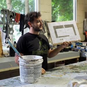 Sean Cox, paint charge, shows an abstract depiction of how light will filter through the trees in one of the sets for "Chamberlain." LISA KRISTOFF/Boothbay Register