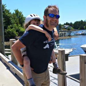 New Boothbay music teacher Mark Phillips with his son, Evan, who doesn't want to play the tuba like his dad because he says “tubas sound like farting.” KATRINA CLARK/Boothbay Register