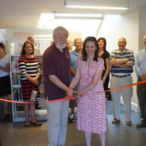 Director of the Boothbay Harbor Memorial Library Tim McFadden and Nicole Poulton, president of the library trustees, cut the ribbon on Saturday, June 28 marking the official grand opening of the newly renovated Boothbay Harbor Memorial Library. KATRINA CLARK/Boothbay Register