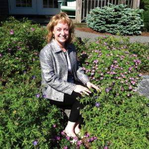 Catherine Wygant Fossett sits in front of the Boothbay Harbor Region Chamber of Commerce, which she will be leaving soon to pursue a new career. SUZI THAYER/Boothbay Register