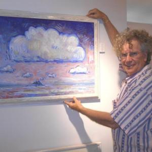 Artist John M.T. Seitzer and hangs his work entitled, "Six Clouds." Seitzer will lead the "Paint & Pour - on the rocks" event at Rocktide on Thursdays from 2 to 4 p.m. through August 28. Courtesy of Rocktide Inn