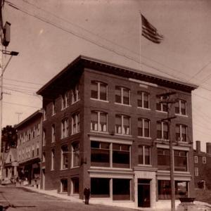 This circa 1910 photo shows the 1906 bank building at the corner of Townsend and Oak in Boothbay Harbor. The upper portion was lopped off in 1963. The abutting building up Oak Street housed Aunt Sadie Knight's rooming house on the upper floors. Courtesy of the Boothbay Region Historical Society