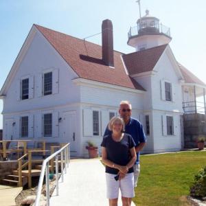 Barb and Dan Aube stand outside the Cuckolds Lighthouse, their home for the summer of 2014. Courtesy of Barb Aube