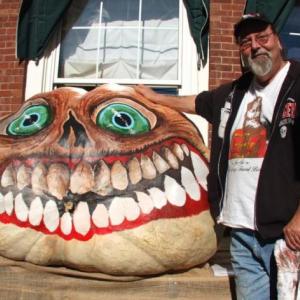 GLENN CHADBOURNE stands beside his pumpkin during Pumpkinfest earlier this month. On Oct. 30 the Damariscotta native will be among those sharing scary stories at the Maine Coast Book Shop. SUZI THAYER/Boothbay Register