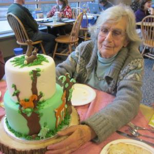 Dahlov Ipcar admires the birthday cake given to her last year by Mid Coast Hospital volunteers, featuring animals from her 2013 republished book, “Animal Hide and Seek.” Courtesy of Millie Stewart Dahlov Ipcar