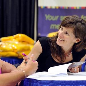 The Rev. Erika Hewitt signs one her books at the UUA General Assembly in Providence, Rhode Island. Courtesy of David Bailey