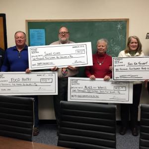 Four local charities were presented checks on Dec. 16 at the Boothbay Elementary School, from McSeagull’s Thanksgiving fundraiser. McSeagull’s employee Jeff Stoddard, left, and manager Alyssa Allen, right, presented the checks to: Tom Wilson (second from left) for the Food Pantry; Elementary School Principal Mark Tess for Santa’s Elves; Peggy Peters for Meals on Wheels; and Sarah Foulger for Food for Thought. SUZI THAYER/Boothbay Register