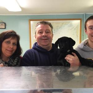 Cathy and Russell Pinkham, along with son Nick Kilgus and newest member of the family, Mandy Mae, at the new Pinkham’s Seafood on Route 27 in Boothbay. SUZI THAYER/Boothbay Register