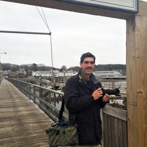 Peter Southwick stands at the entrance to the footbridge in Boothbay Harbor, after spending six months shooting photos and interviewing 12 local people for a journalism project. SUZI THAYER/Boothbay Register