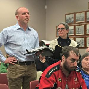 Building Committee Chairman Bob Hilscher, left, expresses his concerns over the municipal process, while church member Mary Neal, right, waits her turn to speak. KATRINA CLARK/Boothbay Register