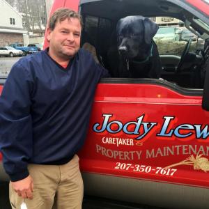 Jody Lewis, with his best friend and co-pilot, Seymour, stands beside one of his vehicles for his new business, Jody Lewis Caretaker & Property Maintenance. SUZI THAYER/Boothbay Register