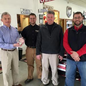 Randall Miller, left, holds the crystal award for customer satisfaction at his dealership in Newcastle. Next to him, left to right: Jay Bilodeau, parts manager; Bruce Haines, finance and insurance manager and Eric Brewer, service and parts director. SUZI THAYER/Boothbay Register