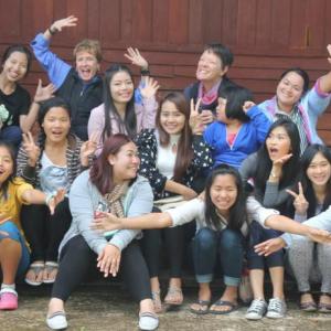 Friends of Thai Daughters founders Patty Zinkowski and Jane McBride with their FTD family, young girls and women who have been helped by the organization over the past decade. The photo was taken this past January at Doi Luang, a remote village in northern Thailand where the inspiration for the FTD began in 2002. Courtesy of FTD