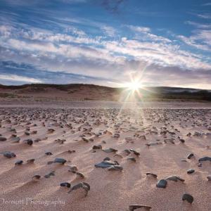 Eva McDermott’s “Sunrise on Inverness Beach” is one of her photographs in her current show at The First in Boothbay Harbor. The show runs through late July. Courtesy of Hilary Bartlett Sunrise on Iverness Beach by