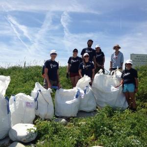 Rozalia Project volunteers and the bags of garbage they filled during their clean-up of Damariscove Island last weekend. Courtesy of the Boothbay Region Land Trust