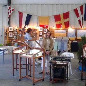 Arts on display in Boat Shed #1 at Hodgdon Yacht Services, with Christine Peters Hamilton and her highly creative jewelry designs in the foreground. Courtesy of Lynn Thompson