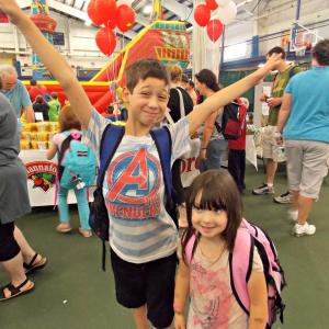 Connor Dover, and his sister, Cali Brown, show off new backpacks they got at Set for Success in 2014. File photo