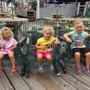 Three sisters take a break in lobster trap chairs in front of Fisherman’s Wharf in Boothbay Harbor on Aug. 20. SUZI THAYER/Boothbay Register