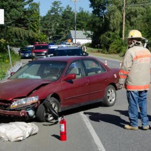 Boothbay Harbor Fire Chief Nick Upham, right, surveys the scene of an Aug. 8 car accident. Courtesy of Peter Southwick