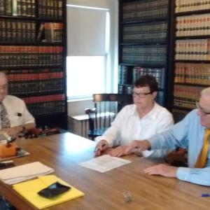 County commissioners William Blodgett (left), Mary Trescot and Hamilton Meserve prepare to sign for the purchase of the county’s newest building. JANE CARPENTER/Boothbay Register