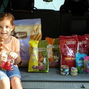 Piper Beck and the donated food items for the Pixel Food Fund. Courtesy of Aubrey Martin