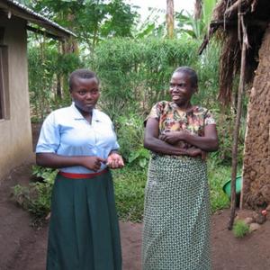 Monica, a 12-year-old student at the URDT Girls School, showed her family how to increase the productivity of their farm and build the new house on the left. Her old mud hut is now the kitchen. Her mom is proud of her. Courtesy photo