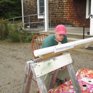 Stephen Gorry of Waldoboro paints a “Peace Pole” he built to help celebrate the 20th birthday of the Quaker meetinghouse in Damariscotta on Oct. 4. Courtesy photo