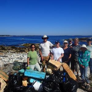 Volunteers from Maine Island Trail Association and L.L. Bean haul trash and debris off Western Cuckolds Island, off Boothbay Harbor. Courtesy of MITA