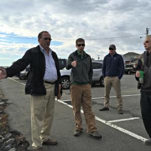 Gathering in the footbridge parking lot to discuss the future of the improvement project. Town Manager Tom Woodin, far left, talks about different ideas he’s heard. To his left, Dan Courtemanch of the DEP, Code Enforcement Officer Geoff Smith, and Bill Royall of Royall Stonework listen. KATRINA CLARK/Boothbay Register