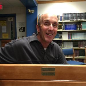 School Resource Officer Larry Brown sits on the “Seahawk Bench” made from the former bleacher boards in the Porter Memorial Gymnasium. KATRINA CLARK/Boothbay Register