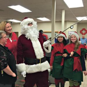 Santa takes a selfie in Key Bank with Donna Gregory, far left, and Kimberly Gates while elves Lovely Uberita and Sierra Murray, far right, look on. KATRINA CLARK/Boothbay Register