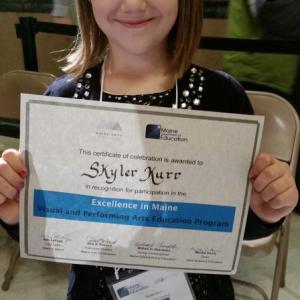 Skyler Kurr of Nobleboro Central, part of AOS 93, attended the celebration of Maine visual and performing arts in Augusta Dec. 4. Here she is with her certificate of achievement, presented by Mrs. Ann LePage. Courtesy of the DOE Skyler Kerr, Nobleboro