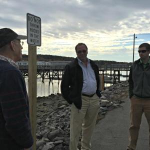 A recent meeting at the footbridge parking lot to determine the feasibility of an improvement project. The footbridge parking lot is one of the town-owned properties that will be directly impacted by the rise in sea levels over the next 50 to 100 years.From left: Selectmen’s Vice Chairman Bill Hamblen, Town Manager Tom Woodin, and Dan Courtemanch of the Maine Department of Environmental Protection. KATRINA CLARK/Boothbay Register