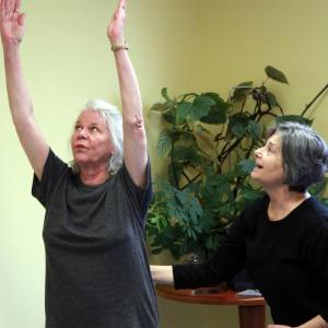 Certified Yoga Therapist Janet Pearce Foster, right, guides a student into a posture at a Yoga Therapy session on the St. Andrews Campus of LincolnHealth. Courtesy of LincolnHealth
