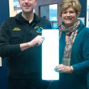 Scott Lash, director of operations for Boothbay Region Ambulance Service and Jane Good, community center director, hold an example of the reflective address signs that are now available from the center. JANE CARPENTER/Boothbay Register