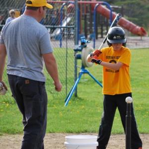 Boothbay Region Baseball Association member Bill Mansfield instructs Finn Harkins during a T-ball game in 2015. Courtesy of Leah Plummer